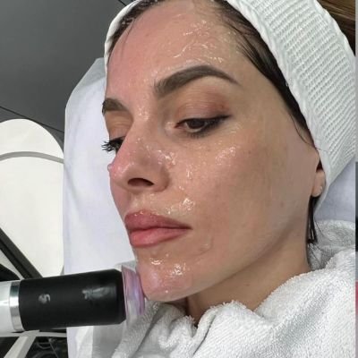 Woman receiving a hydrating facial treatment using advanced skincare equipment.